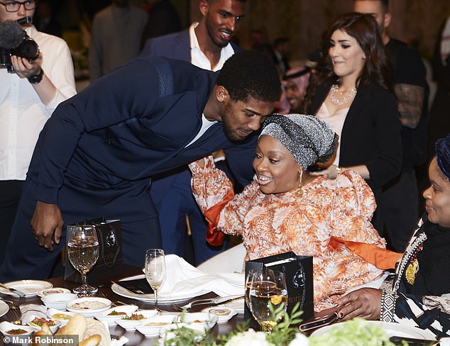 The British boxer maintains deep ties to his parents' homeland (pictured with his mother Yeta)